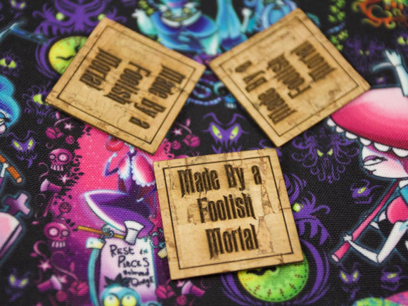 Made by a Foolish Mortal Mini Tags on Cork